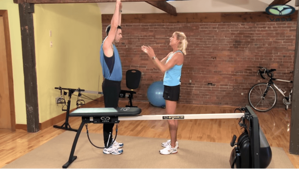 Raising arms up as if to grab a pull-up bar