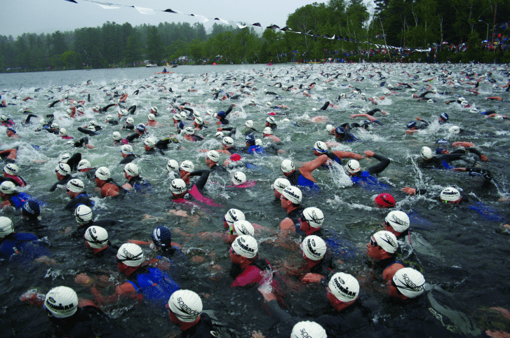 A group of triathlon swimmers in open water